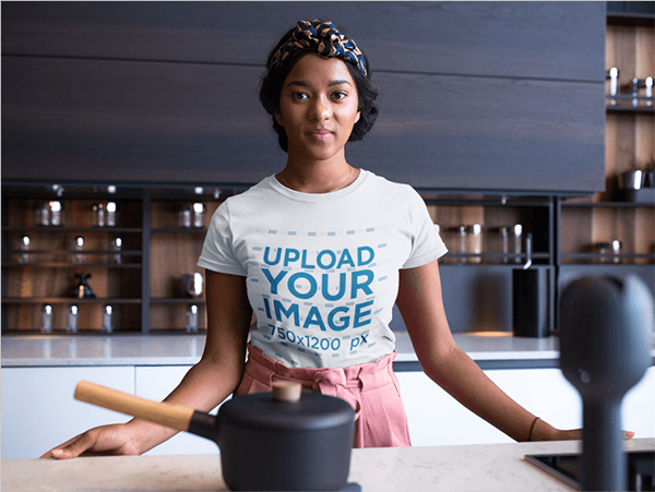 woman wearing a round neck tshirt mockup while in her kitchen counter